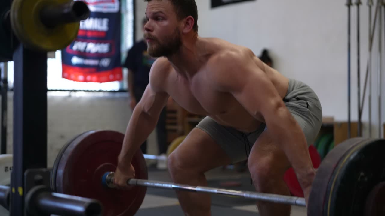 A lifter grinding through a heavy pull in the gym.